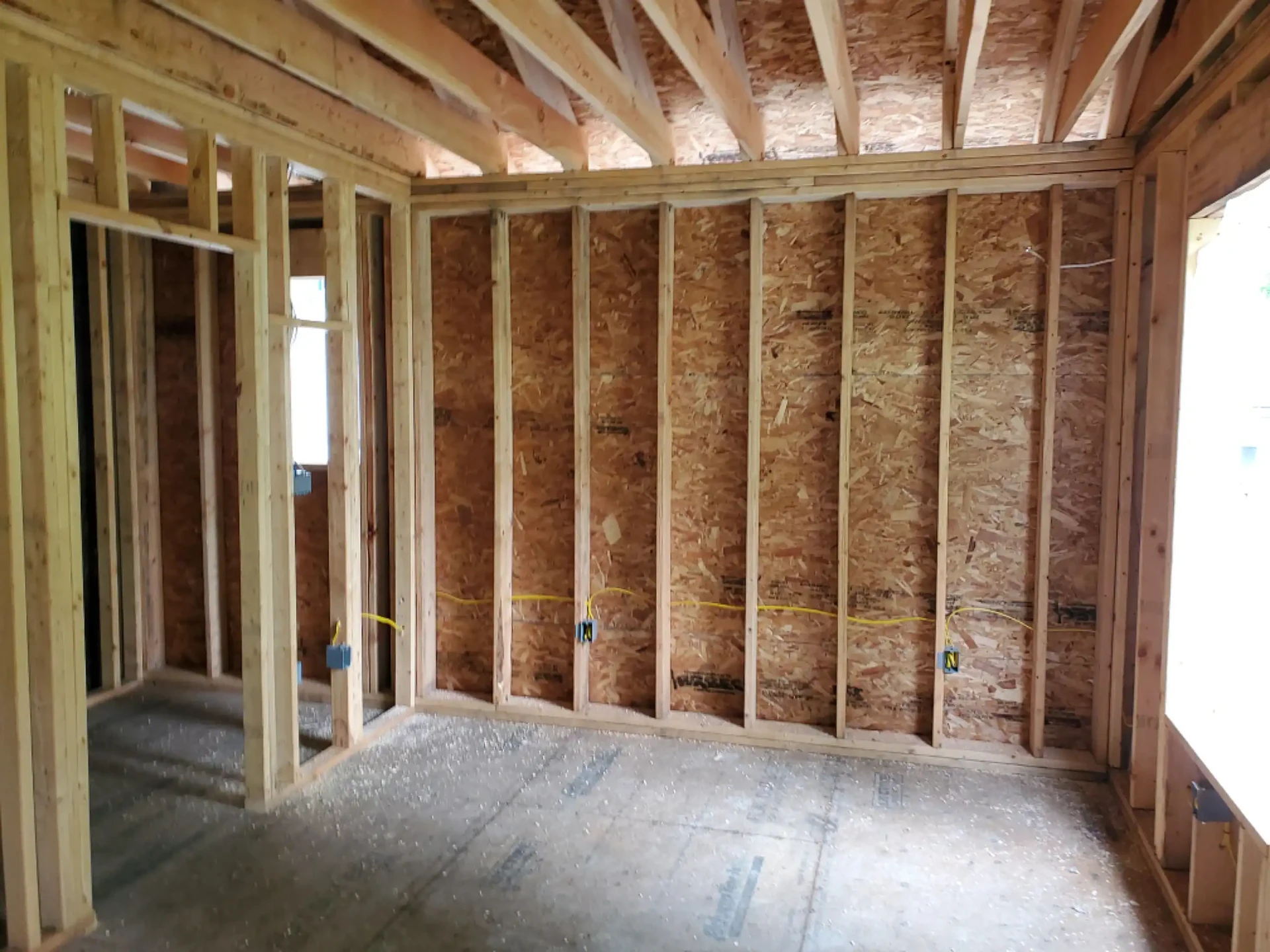 Outlet boxes and wiring along a framed bedroom wall
