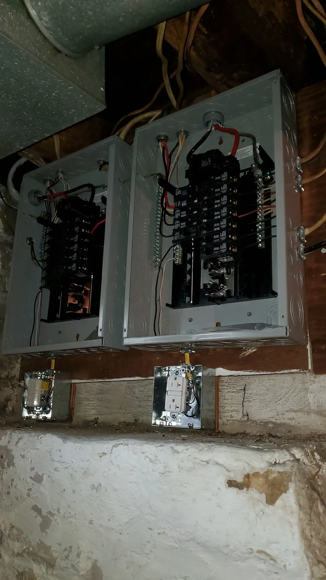 Neatly wired twin breaker panels with GFCI receptacles below